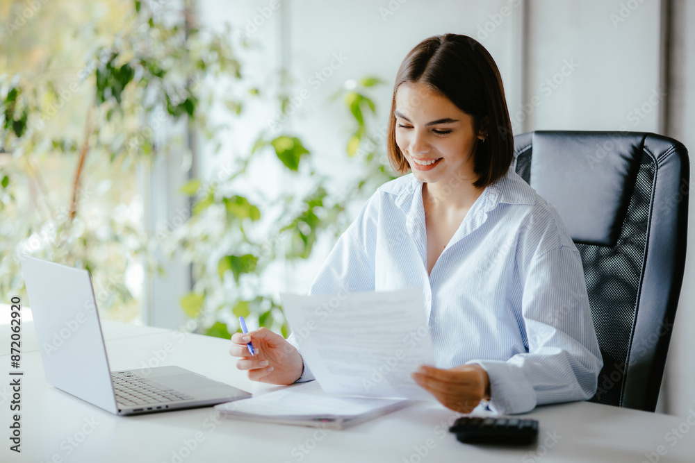 Smiling businesswoman working at desk Smiling businesswoman working at desk