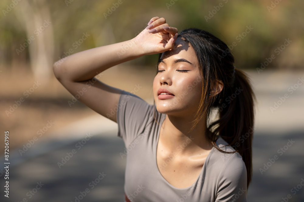 A woman is sitting on the ground and looking up at the sky