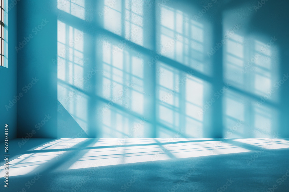 Interior of empty spacious room with window shadows and sunlight on blue wall. Interior of empty spacious room with window shadows and sunlight on blue wall.