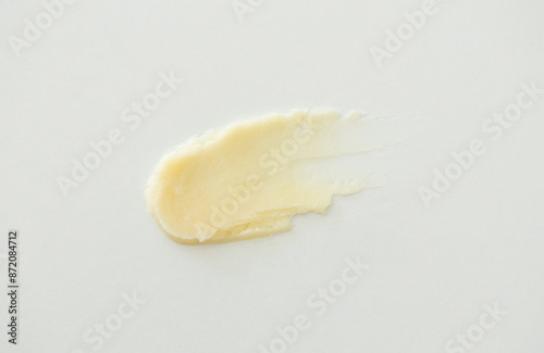 Lip balm stroke swatch. Skincare texture balm beauty product smear minimalist on white background photo