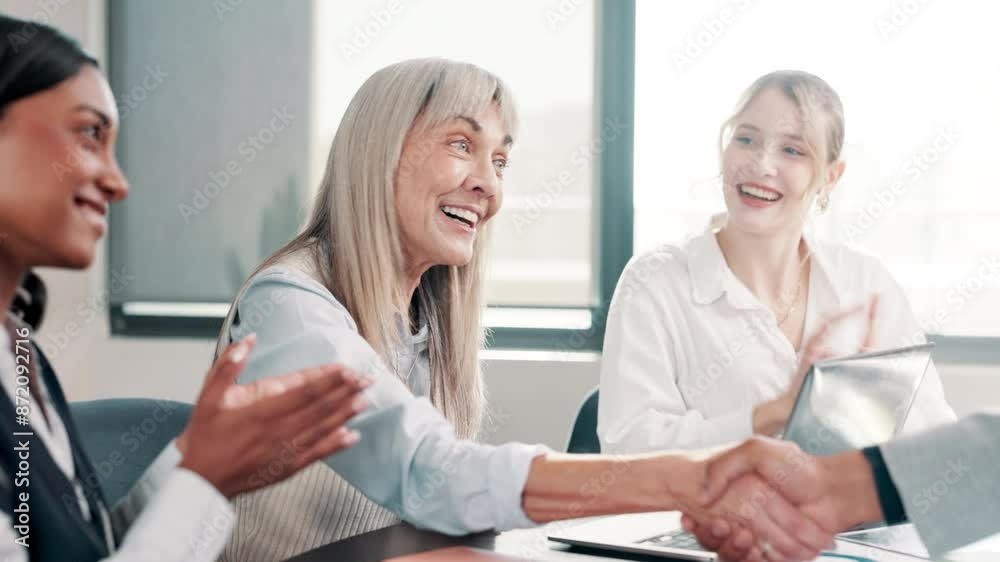Business meeting, handshake and laptop in office for collaboration, teamwork and partnership. Mature woman, project manager and tech for agreement, choice and decision with celebration for promotion Business meeting, handshake and laptop in office for collaboration, teamwork and partnership. Mature woman, project manager and tech for agreement, choice and decision with celebration for promotion