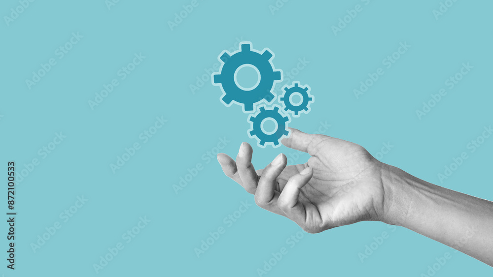 Hand is holding metal gears and cogwheels mechanism representing interaction teamwork concept. Process in progress. Empty space for the text Hand is holding metal gears and cogwheels mechanism representing interaction teamwork concept. Process in progress. Empty space for the text