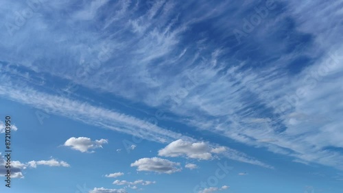 Sharp shaped cloud wave moves next to the other clouds at sunset