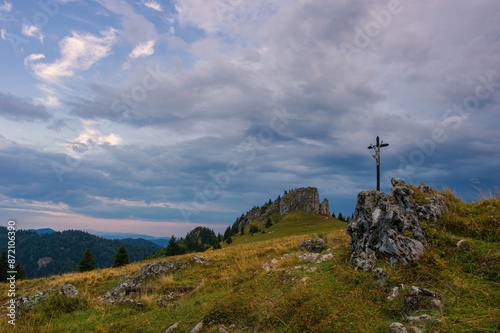 Mountain landscape with rocks, pastures for cattle and a small cross in the foreground. Slovak mountain nature Velka Fatra, Kralova Studna photo