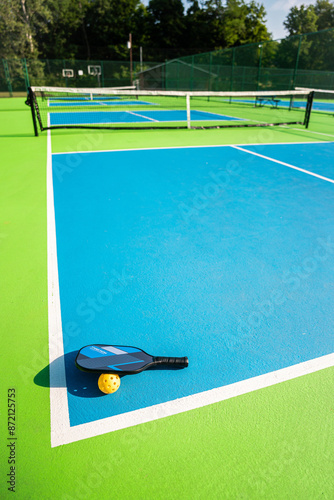 pickleball paddle and ball at an outdoor court