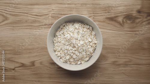 A bowl of oatmeal sits on a wooden table