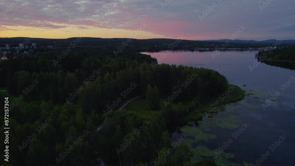 Sunset over a peaceful lake during the summer in Sweden. Shot with a drone. Sunset over a peaceful lake during the summer in Sweden. Shot with a drone.