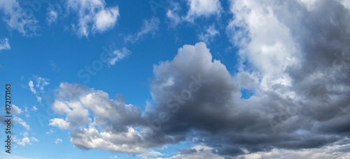 Obraz na plátne Gray rain clouds are approaching the blue sky