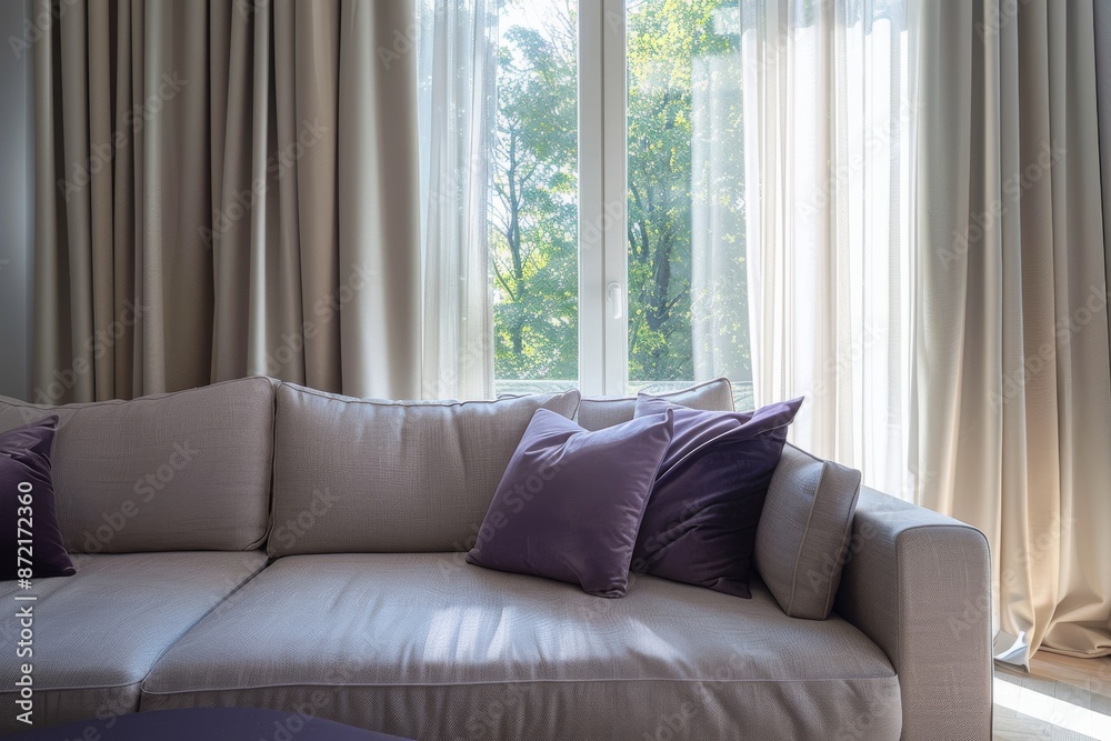 Interior of living room with sofa, pillows and window view Interior of living room with sofa, pillows and window view