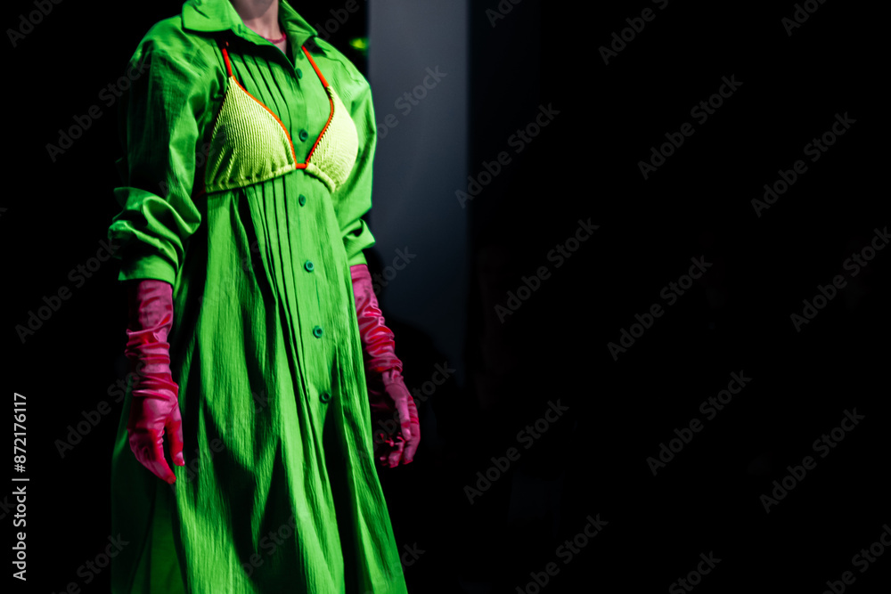 Fototapeta premium Bright green dress, bra and pink gloves. Women's creative fashion design and stylish accessories. Fashion week details