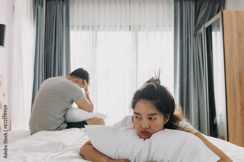 Asian couple lover, wife is sulking on the bed and husband turn his back. Asian couple lover, wife is sulking on the bed and husband turn his back.