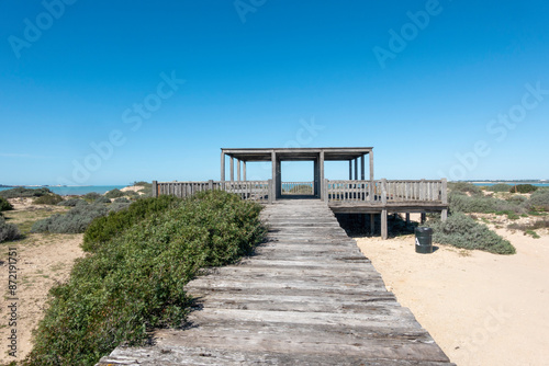 View with a wooden path leading to a viewpoint located in the Torunos Natural Park, in El Puerto de Santa María, Cadiz, Spain photo