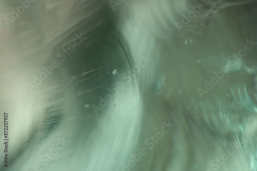 Naturally abstract, delicate and flowing shape lines. Highlighted wavy lines and blurred background. Soft green. Dark, moody feeling.