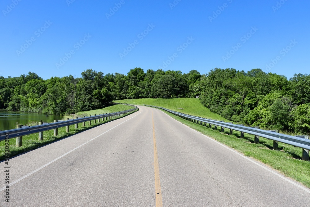 The empty road in the countryside on a sunny day.