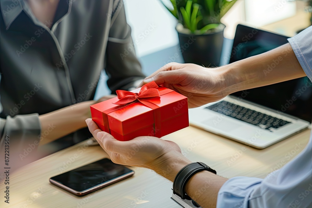 Fototapeta premium woman holding a red gift box for the bos