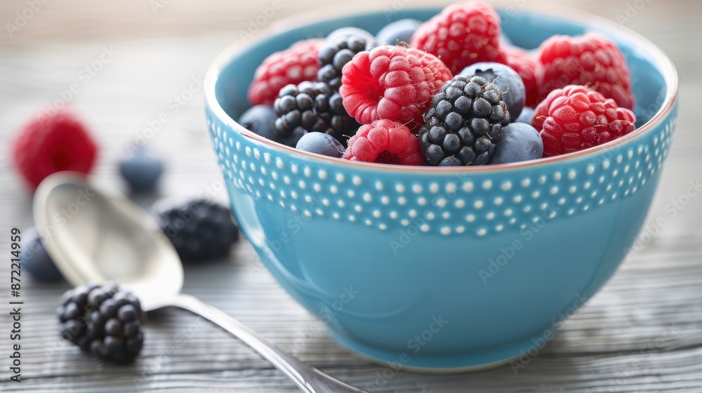 Fresh Berries in Blue Bowl - Close-up of a blue bowl filled with fresh raspberries, blackberries, and blueberries, capturing their vibrant colors and juicy textures. Fresh Berries in Blue Bowl - Close-up of a blue bowl filled with fresh raspberries, blackberries, and blueberries, capturing their vibrant colors and juicy textures.