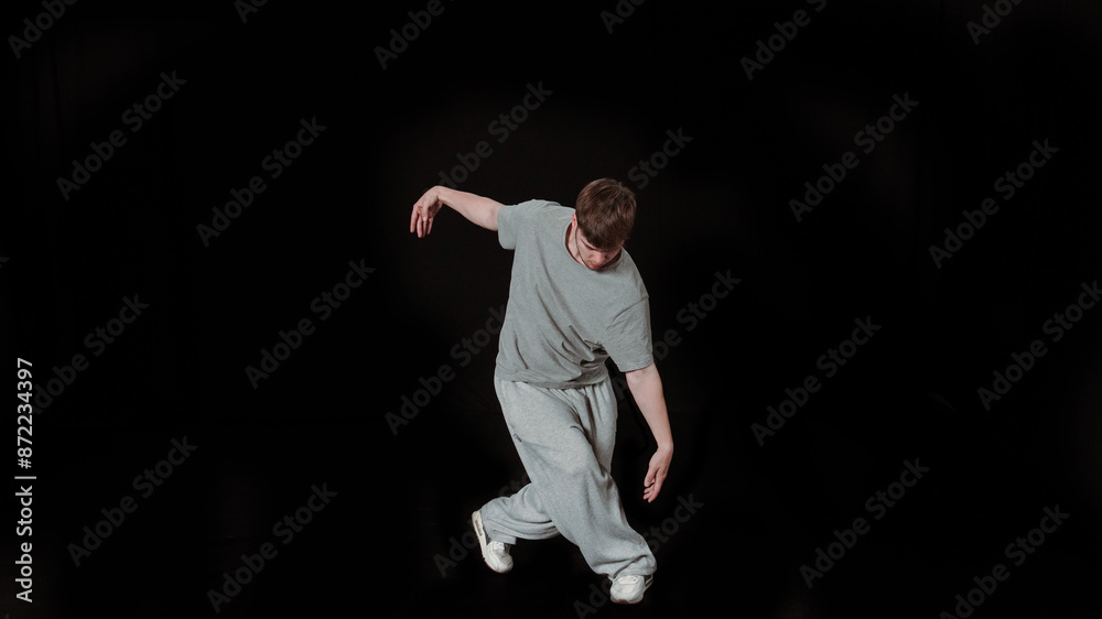 Expressive Male Dancer Performing Modern Dance in Grey T-shirt