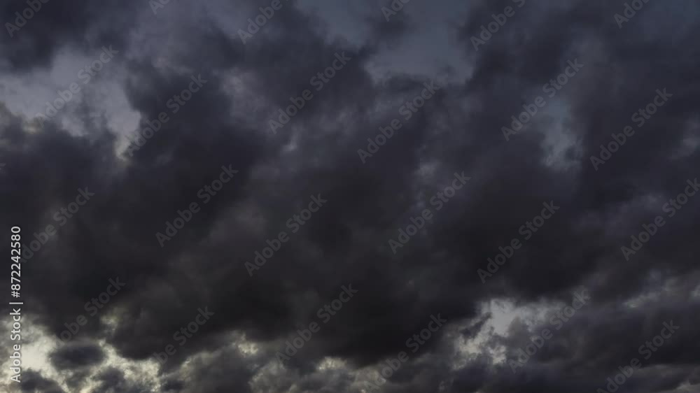 Magical landscape of dark clouds moving across the sky at dusk Magical landscape of dark clouds moving across the sky at dusk