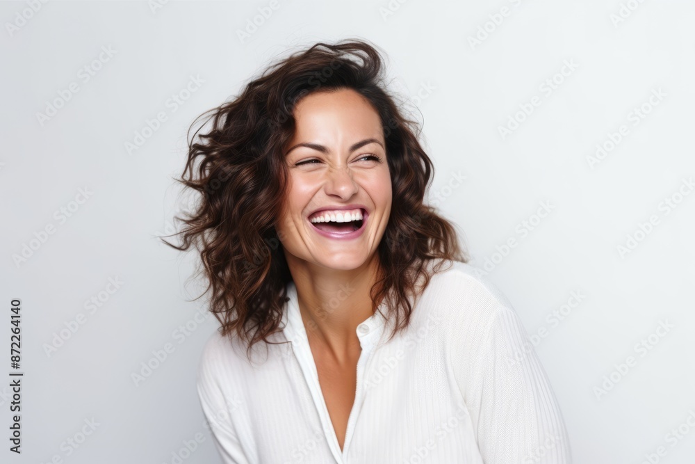 Closeup portrait of a happy young woman laughing against a white background Closeup portrait of a happy young woman laughing against a white background