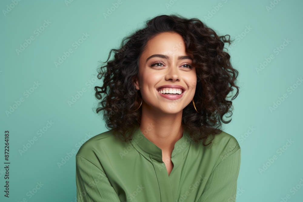 Portrait of happy young woman with curly hairstyle and green shirt Portrait of happy young woman with curly hairstyle and green shirt