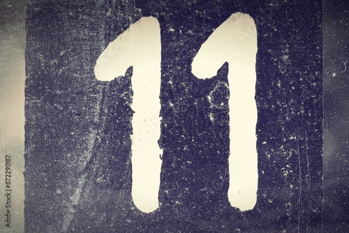 Number 11, White number on a dark background. Old photo