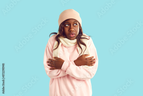 Φωτογραφία Portrait of unhappy African American woman who is freezing because of cold weather and can't keep warm