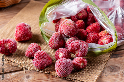 Frozen strawberries on a table. Frozen food, frozen fruit photo