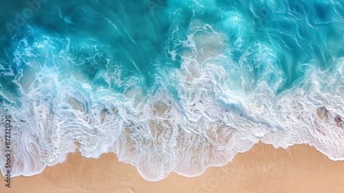 An aerial view of ocean waves gently washing over a sandy shore, showing the beauty of the coastline and the seamless blend of water and land in a serene, natural setting.