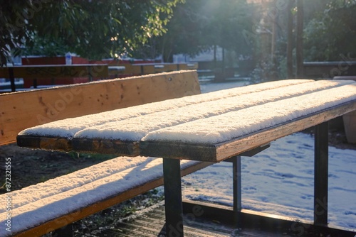 Εκτύπωση καμβά Une table de pique-nique en bois totalement recouverte de neige et éclairée par