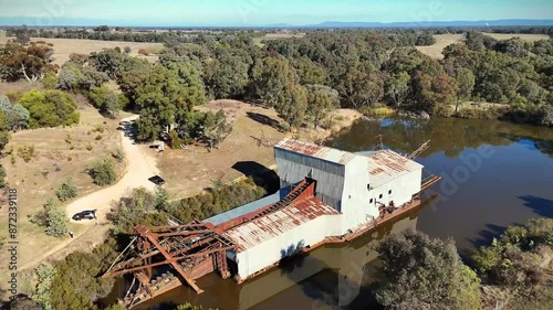 Aerial of the eldorado gold dredge on a small lake next to trees photo