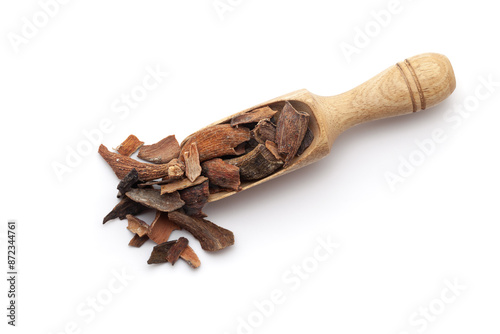 Top view of a wooden scoop filled with dry Organic Zebrawood or Kakda Singi (Pistacia integerrima). Isolated on a white background. photo