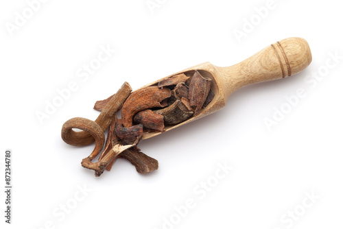 Top view of a wooden scoop filled with dry Organic Zebrawood or Kakda Singi (Pistacia integerrima). Isolated on a white background. photo