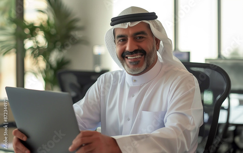 Smiling mid age Arab Man at Work , Arab man in office smiling , Arab man office senior with laptop