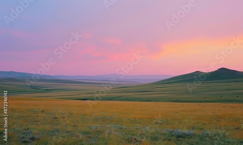 photograph of vast Mongolian grasslands at dusk with rolling hills and distant mountains under a pastel sky with pink and purple hues