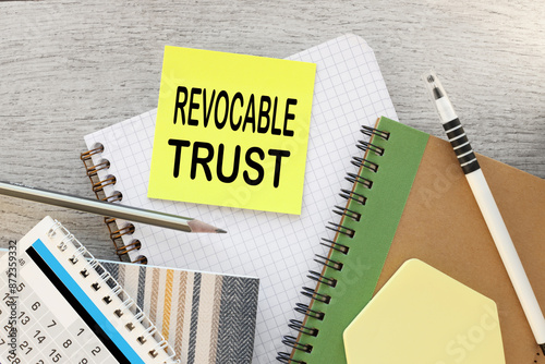 Revocable trust yellow sticker with text on the desktop near the calendar