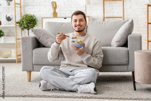Handsome young man eating t...