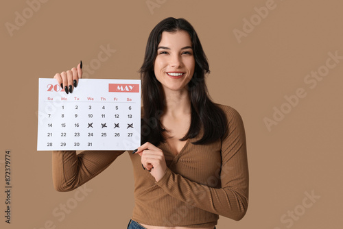 Pretty young woman holding ...