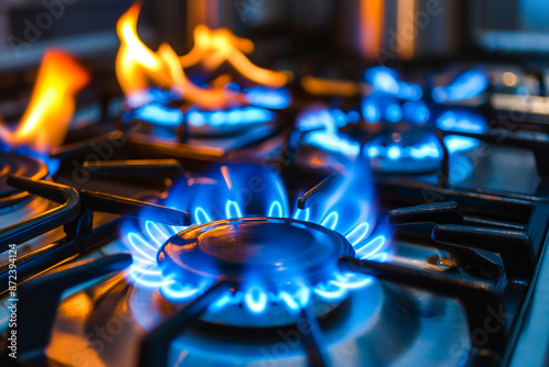 Close up shot of blue fire from domestic kitchen stove top. Gas cooker with burning flames of propane gas. Gas supply chain and news. Global gas crisis and price rise