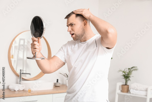 Worried young man with hair...