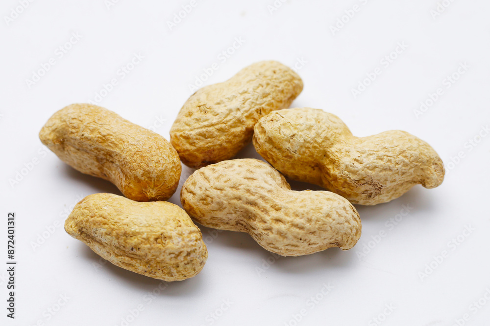 Roasted peanuts in shell on white background. Roasted peanuts in shell on white background.
