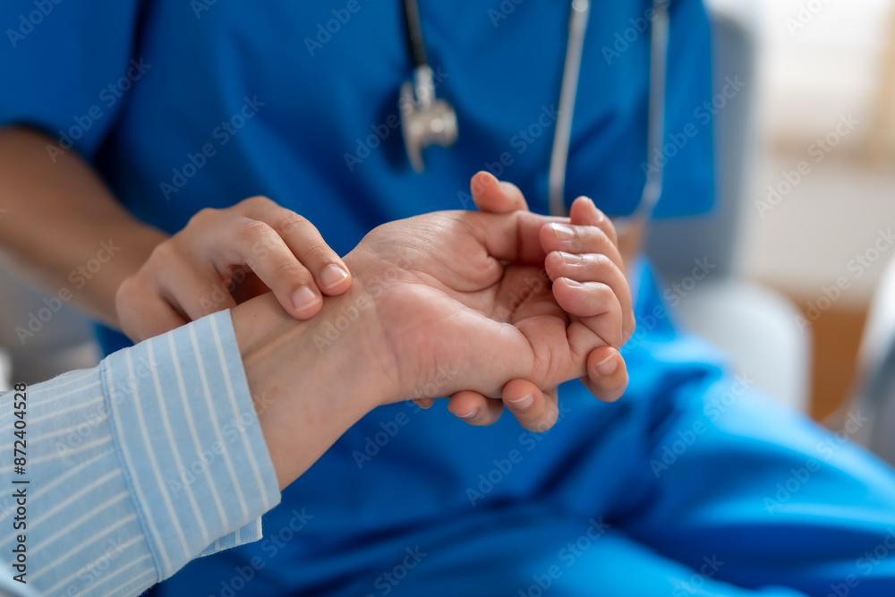Fototapeta premium Caring Nurse Checking Patient's Pulse at Home - Home Care, Health, and Medical Assistance Concept