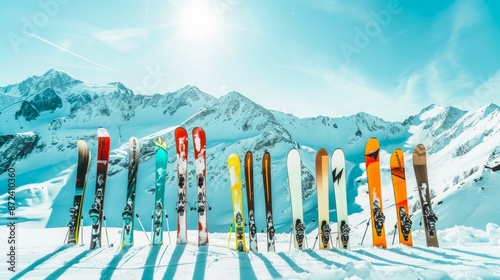 Colorful Skis Lined Up on Snowy Mountain Top, Concept of Winter Sports, Ski Equipment, Mountain Scenery. Copy space