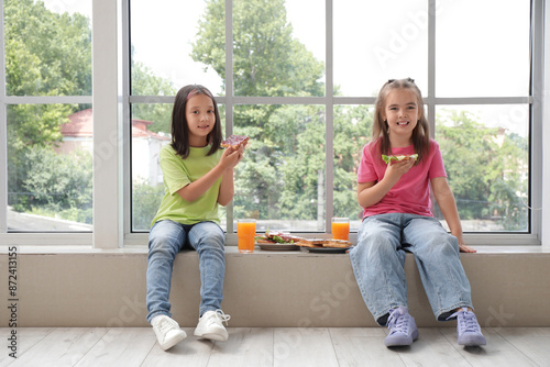 Cute little girls with tast...