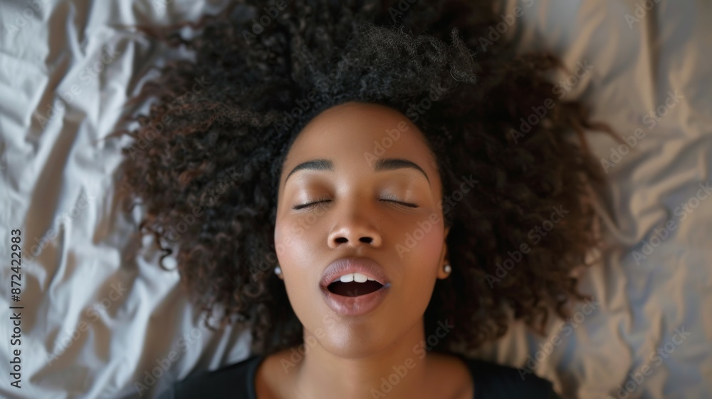 Close-up of a woman's face during orgasm in bed. Background with selective focus Close-up of a woman's face during orgasm in bed. Background with selective focus