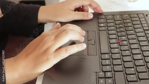 Female hand moving the laptop touchpad.  The video was taken close up