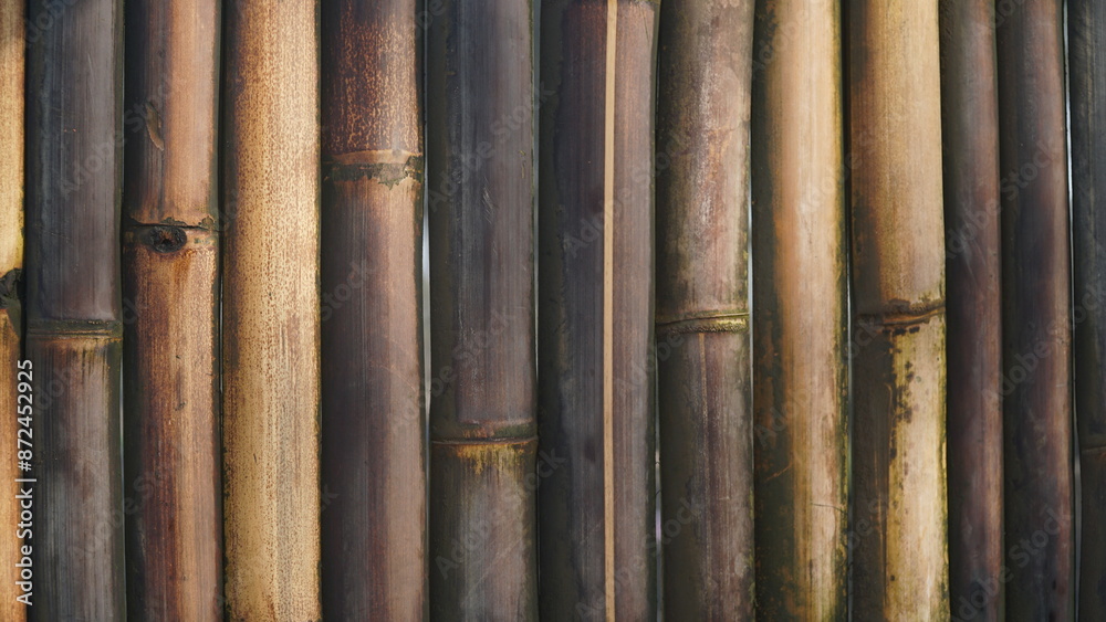 An arrangement of brown and black bamboo sticks, for a fence or wall. An arrangement of brown and black bamboo sticks, for a fence or wall.