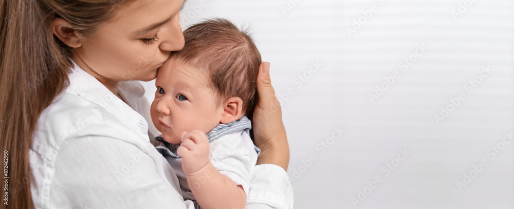 Mother holding her small baby on light background. Banner design with space for text Mother holding her small baby on light background. Banner design with space for text
