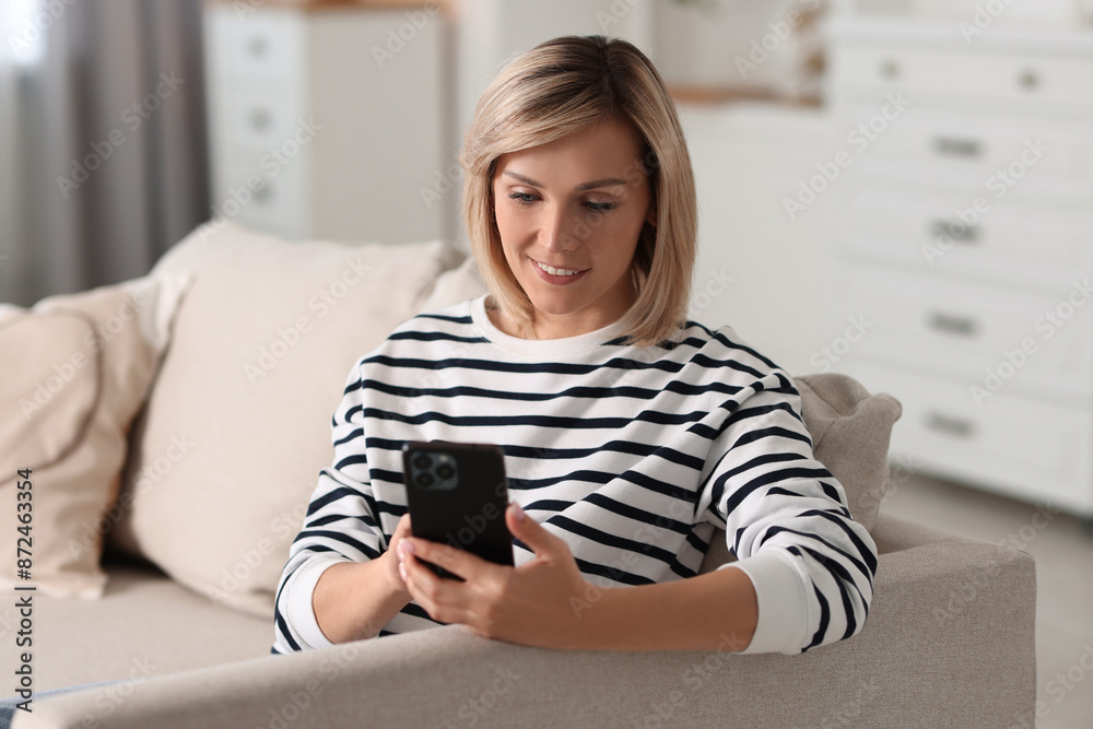 Happy woman using mobile phone at home Happy woman using mobile phone at home