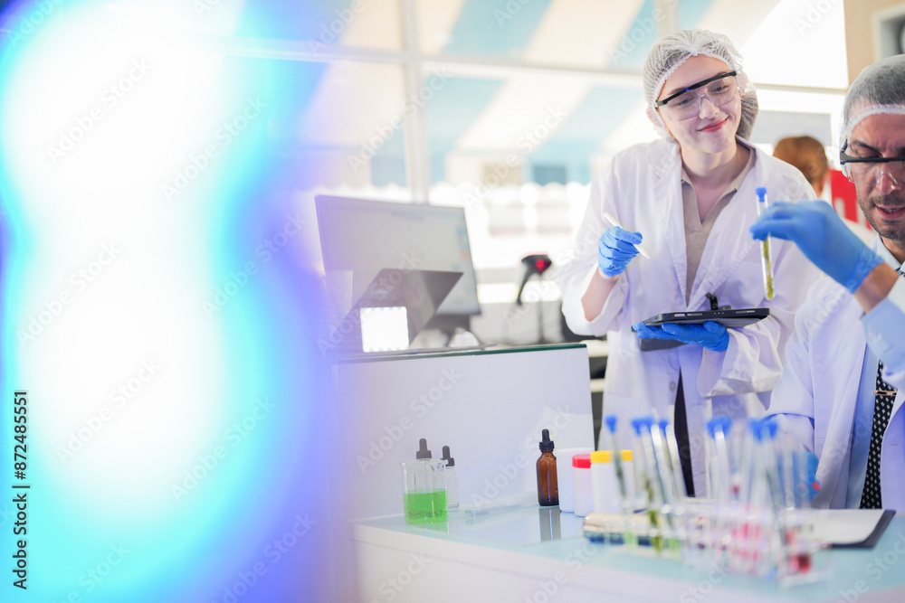 scientists perform experiments and record data. people arranges equipment with test tubes and chemicals for producing medicine and biochemistry. man hold tubes of chemical liquids and plant samples. scientists perform experiments and record data. people arranges equipment with test tubes and chemicals for producing medicine and biochemistry. man hold tubes of chemical liquids and plant samples.