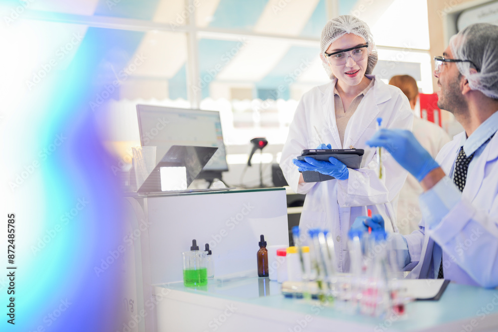 scientists perform experiments and record data. people arranges equipment with test tubes and chemicals for producing medicine and biochemistry. man hold tubes of chemical liquids and plant samples. scientists perform experiments and record data. people arranges equipment with test tubes and chemicals for producing medicine and biochemistry. man hold tubes of chemical liquids and plant samples.